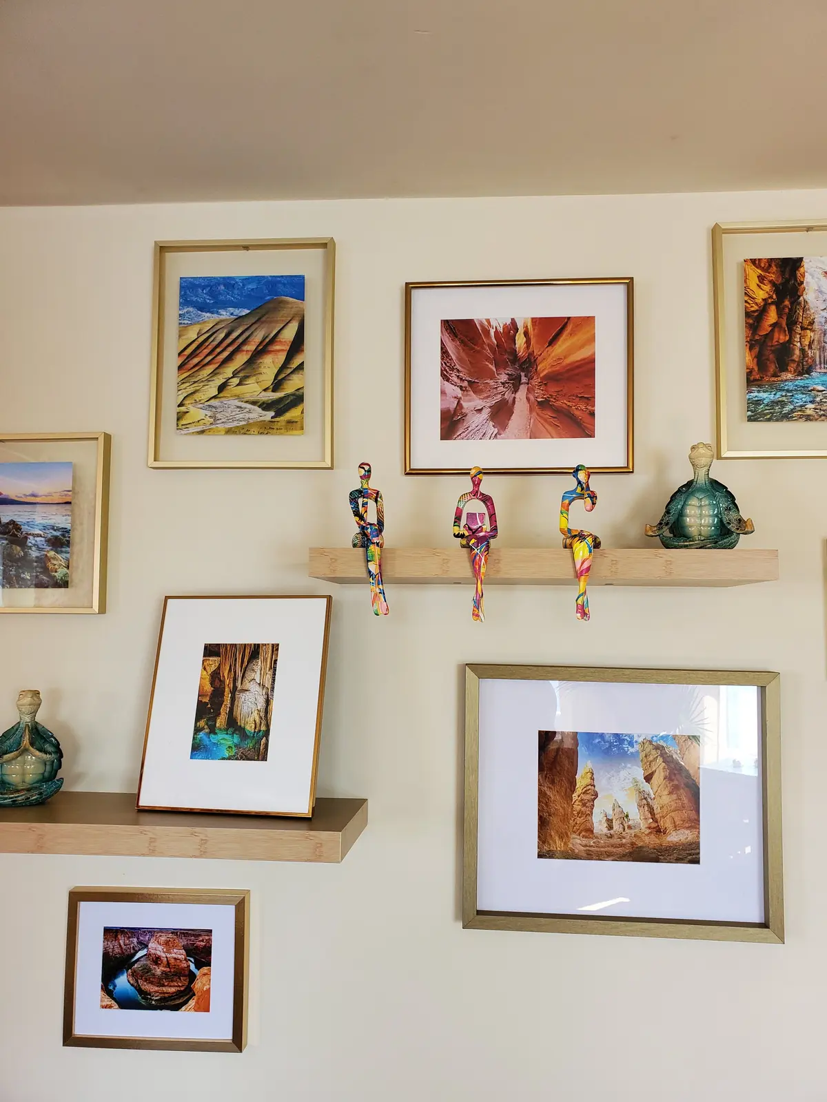 Artful styling detail with layered frames and collected objects — designed by Renata Glaz