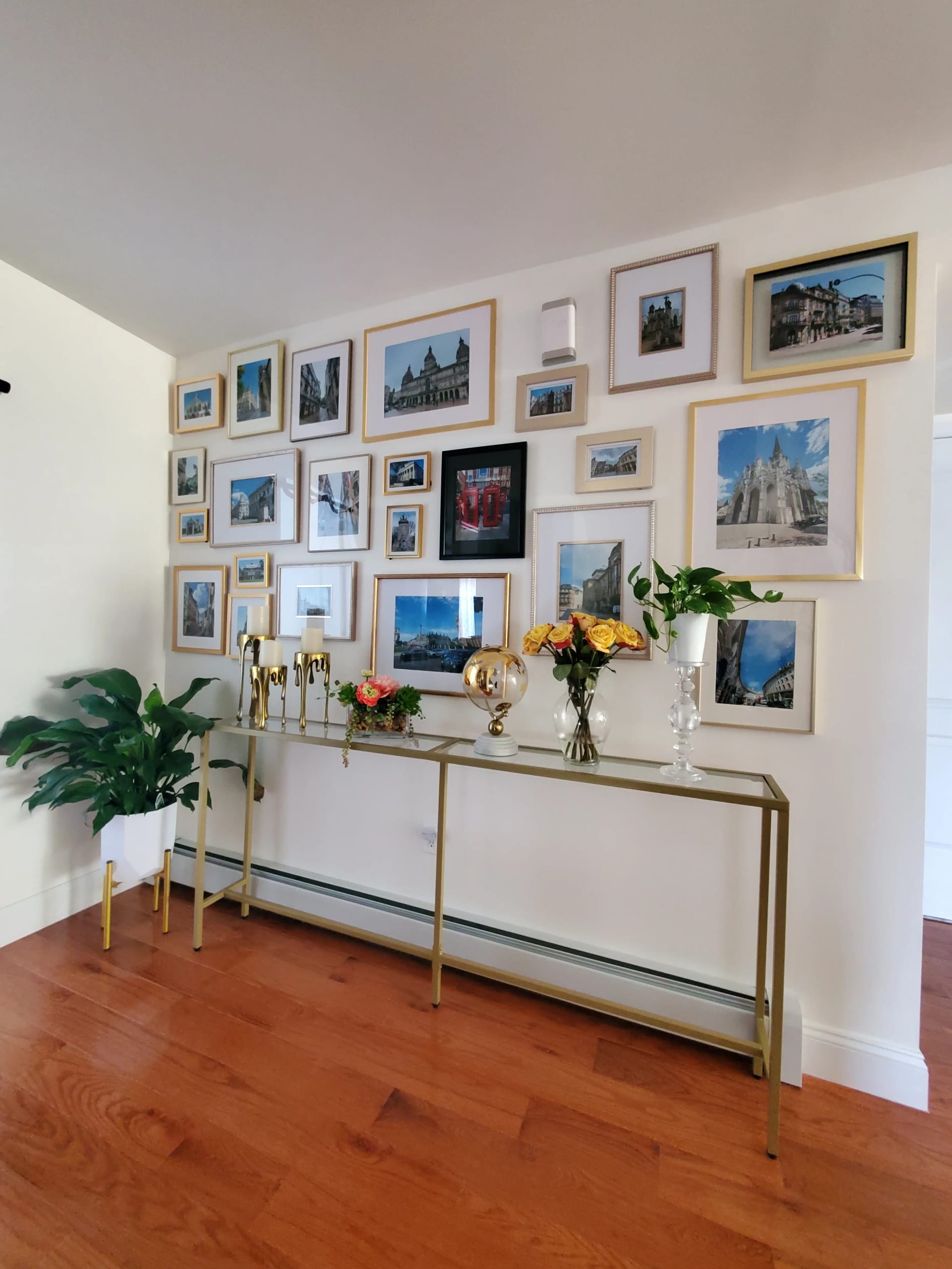 Renata Glaz interior design entryway with curated gallery wall and warm gold accents