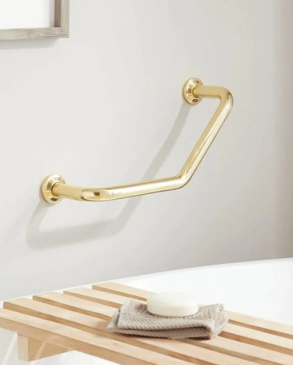 Designer grab bar in a polished finish styled into a refined bathroom setting - by Renata Glaz